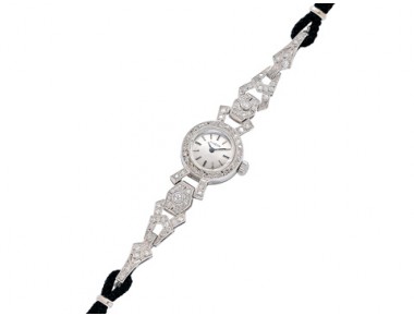 Vintage Omega lady’s platinum and diamond manual-wind cocktail wristwatch with silvered baton dial on black rope strap, length 7 inches