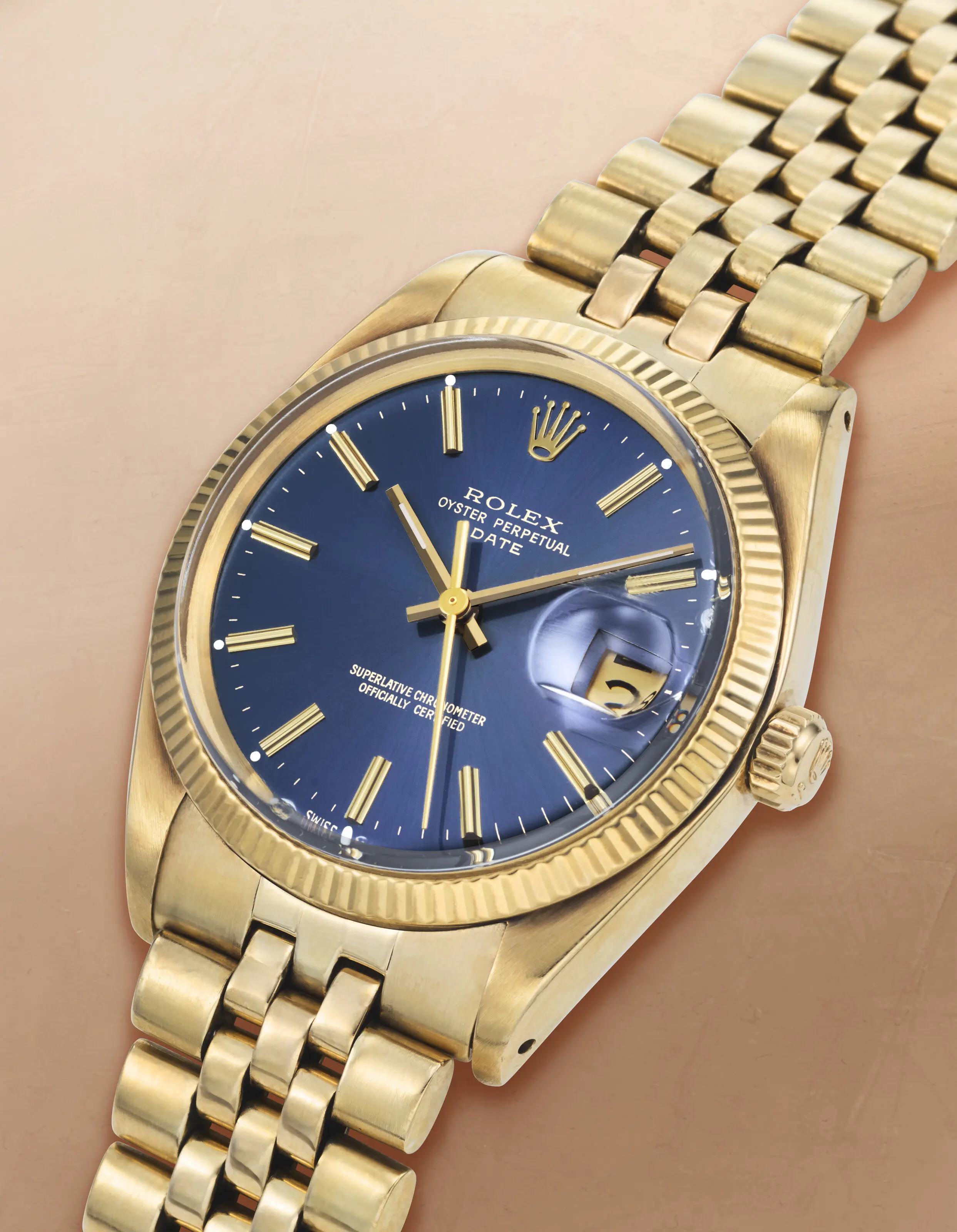 Vintage 1976 Rolex Oyster Perpetual Date Reference 1503 watch featuring a solid 14K gold case, a deep blue dial, and a matching 14K gold Jubilee bracelet.