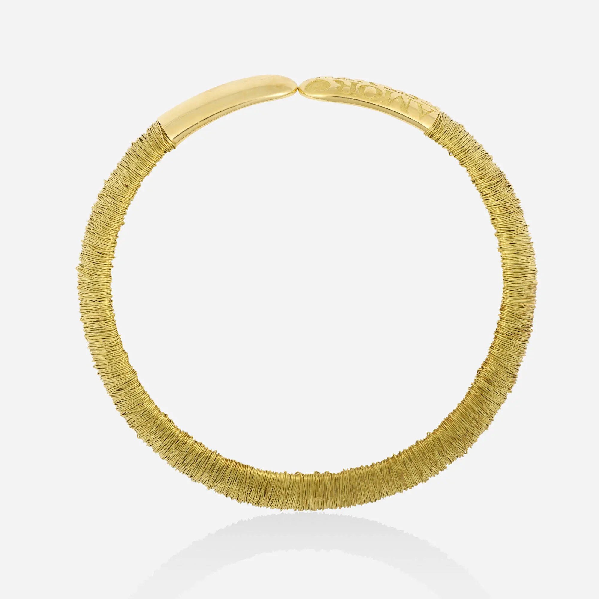 Pasquale Bruni 18k yellow gold and steel wrapped wire collar necklace showing the 'AMOR EST VITA' engraving on the terminal.