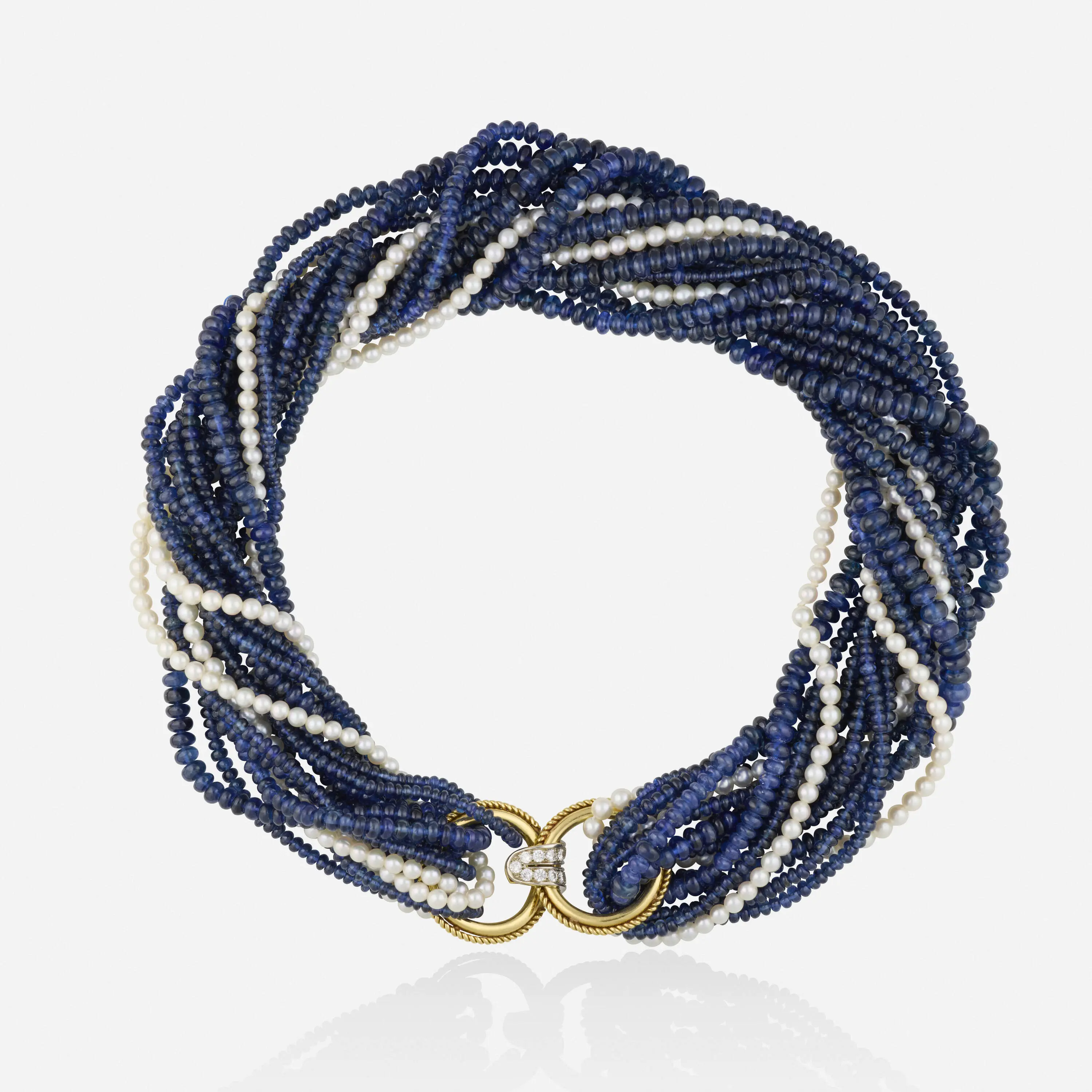 High-luxury six-strand choker necklace with four strands of sapphires, two strands of cultured pearls, and a yellow and white gold roped clasp set with round brilliant-cut diamonds.