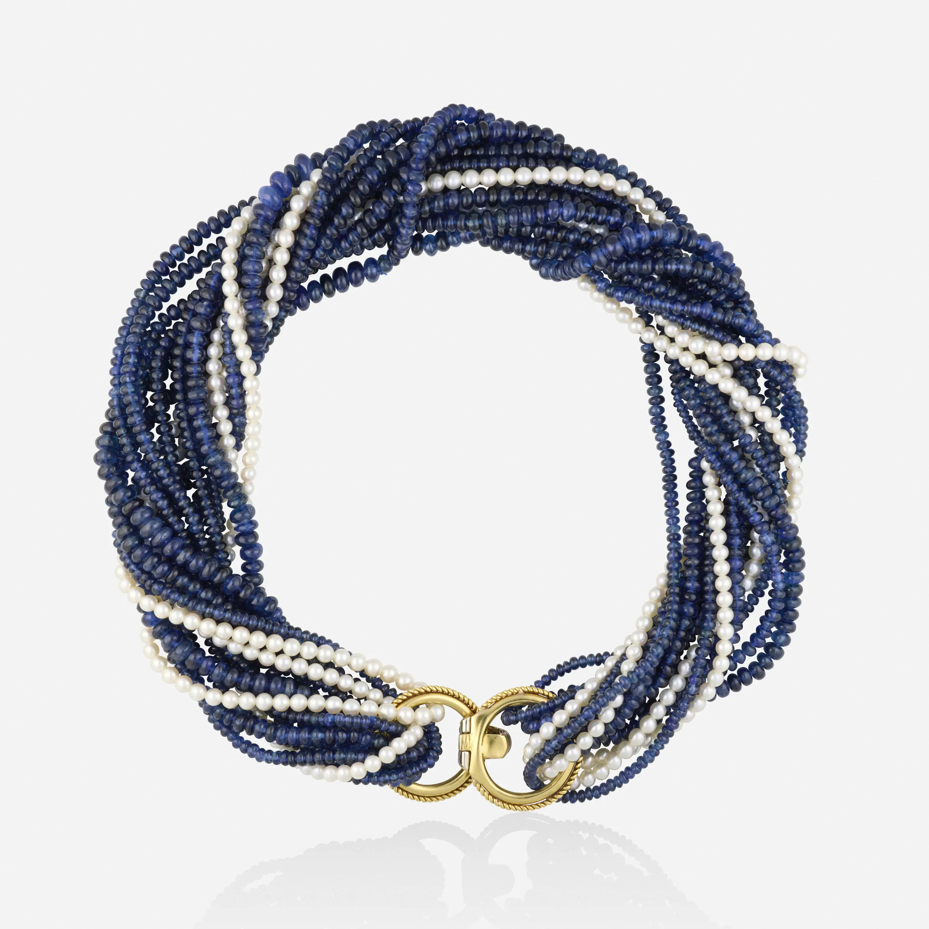 High-luxury six-strand choker necklace with four strands of sapphires, two strands of cultured pearls, and a yellow and white gold roped clasp set with round brilliant-cut diamonds.