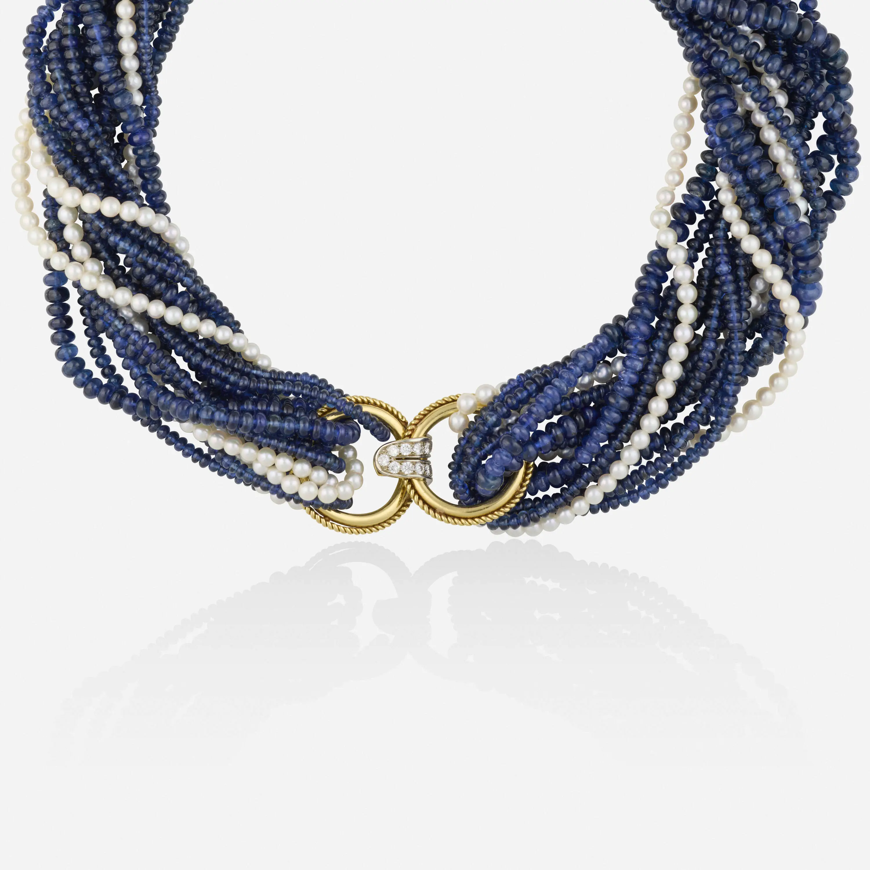 High-luxury six-strand choker necklace with four strands of sapphires, two strands of cultured pearls, and a yellow and white gold roped clasp set with round brilliant-cut diamonds.