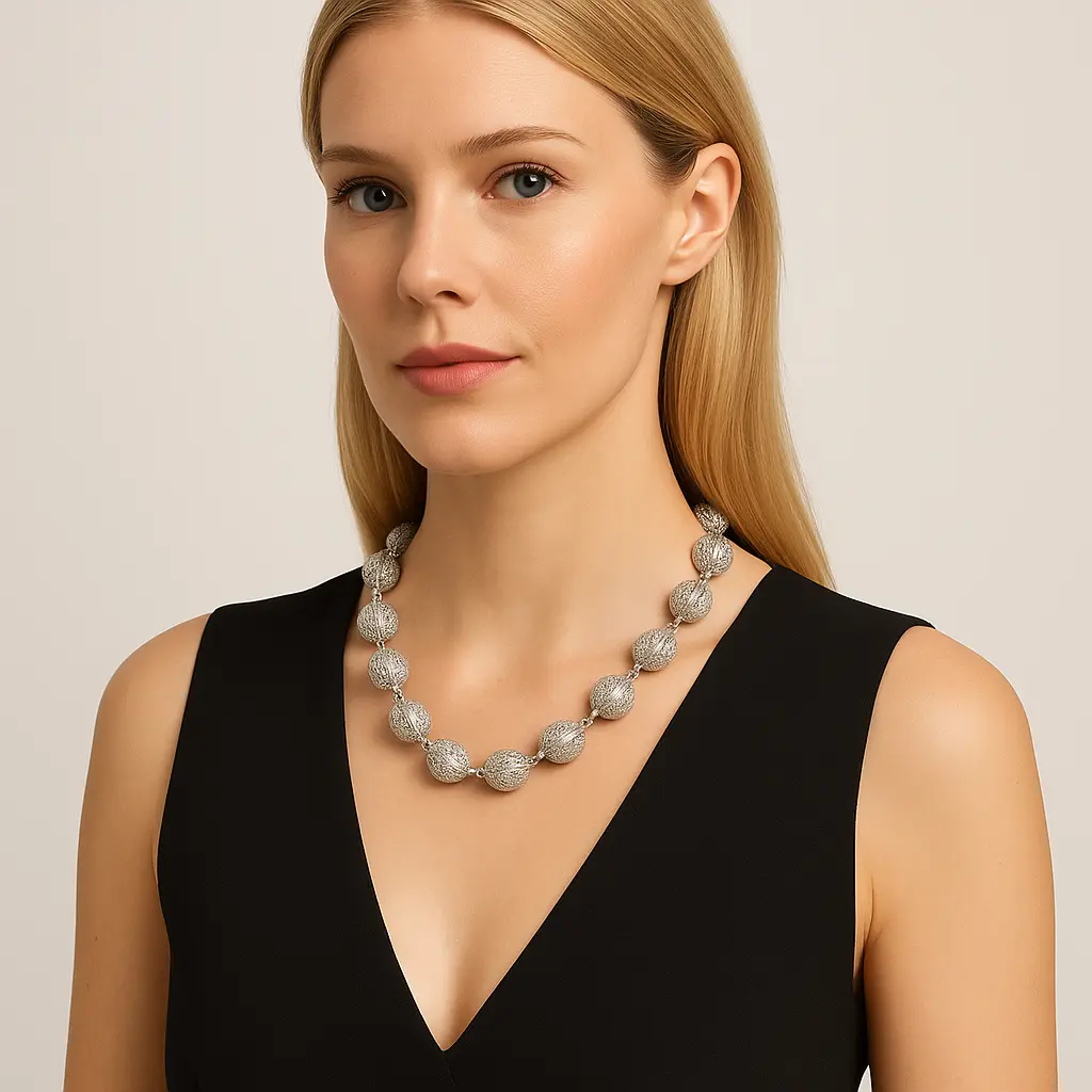 Judith Ripka 18K white gold diamond truffle-ball necklace with textured pavé spheres, approx. 18 inches long and 16 mm wide.