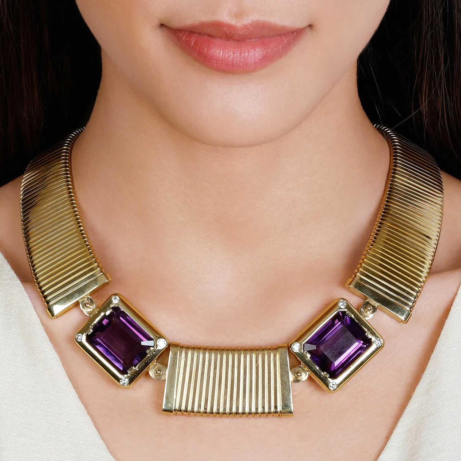 Carlo Weingrill 18K gold tubogas necklace with step-cut amethysts, styled editorial image