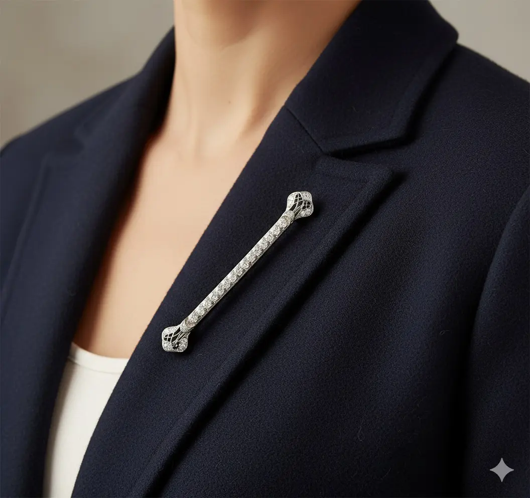 Platinum diamond bar brooch, 3 inches, bead-set old European-cut diamonds in a milgrained line with pierced decorative terminals.