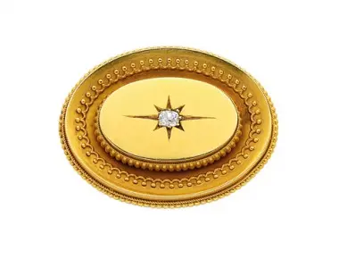 Antique Victorian 18K yellow-gold oval brooch with beaded borders and central star-set old mine-cut diamond, c.1860