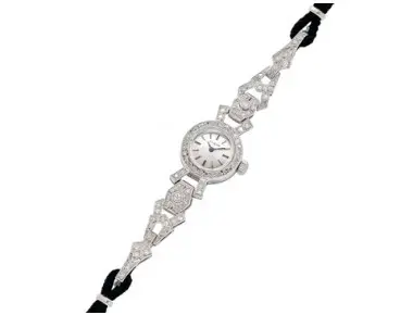 Vintage Omega lady’s platinum and diamond manual-wind cocktail wristwatch with silvered baton dial on black rope strap, length 7 inches